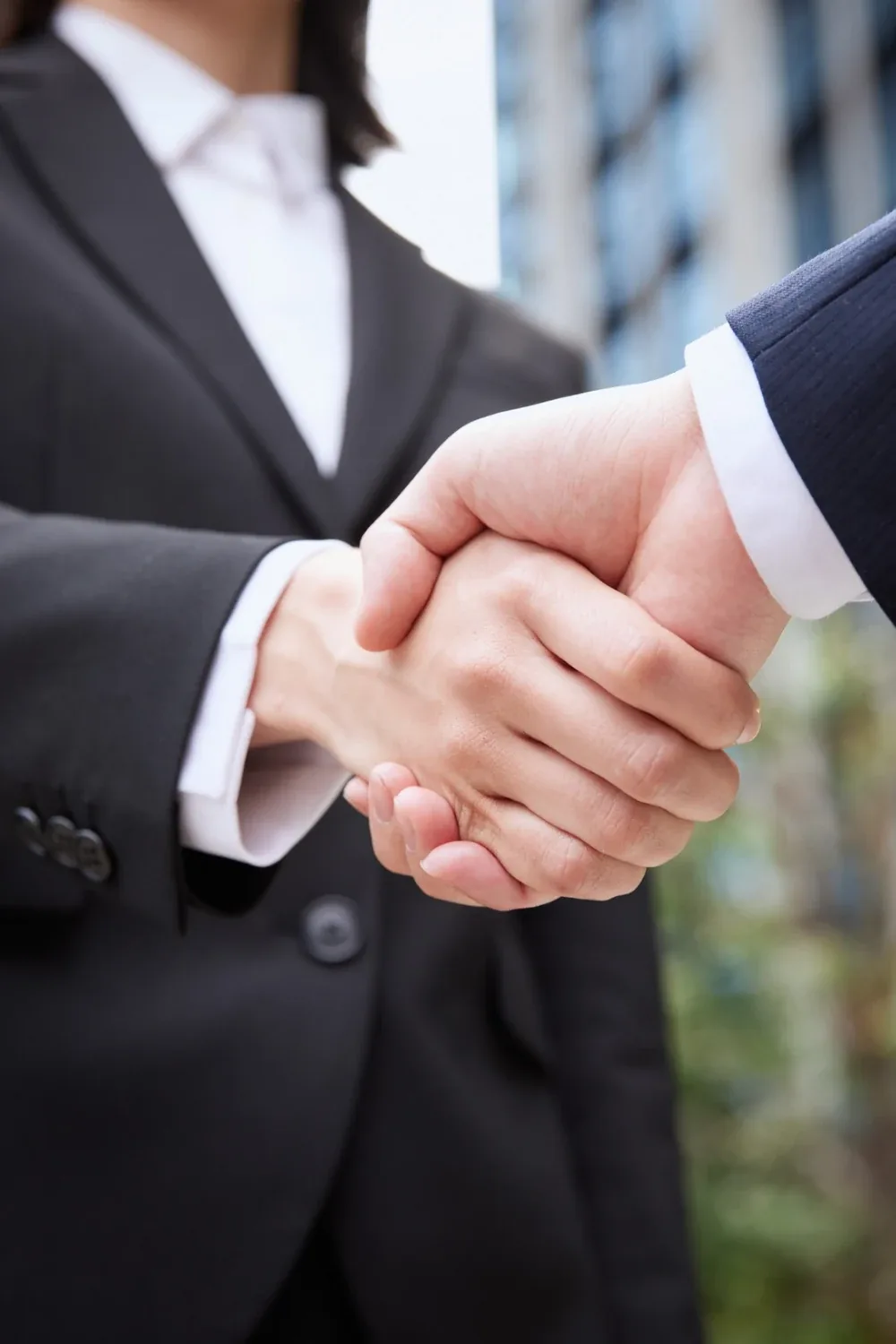 US business travel visa — a business handshake with a city skyline in the background